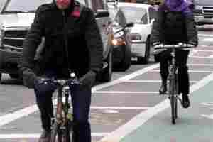 Two cyclists brave the elements to use the Columbus Avenue bike lane on the same frigid day a NY Times reporter observed scant cyclists.